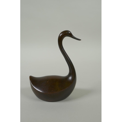 191 - An oriental bronze figure of a stylised duck, 10cm high