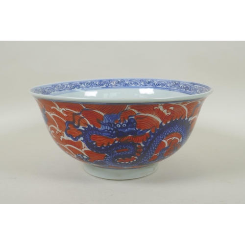 193 - A Chinese blue and white porcelain bowl decorated with dragons on red saves, Xuande 6 character mark... 