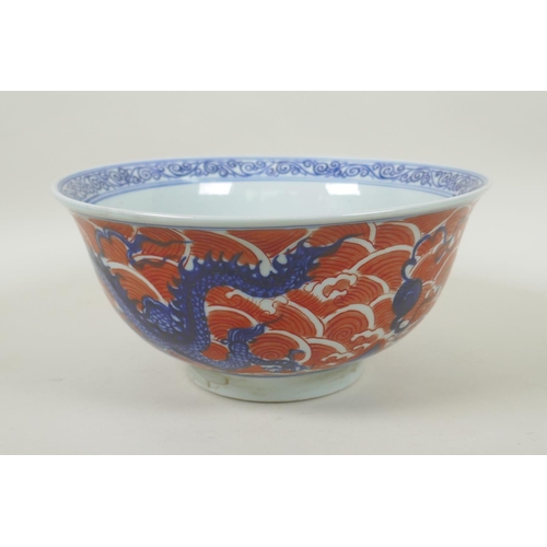 193 - A Chinese blue and white porcelain bowl decorated with dragons on red saves, Xuande 6 character mark... 