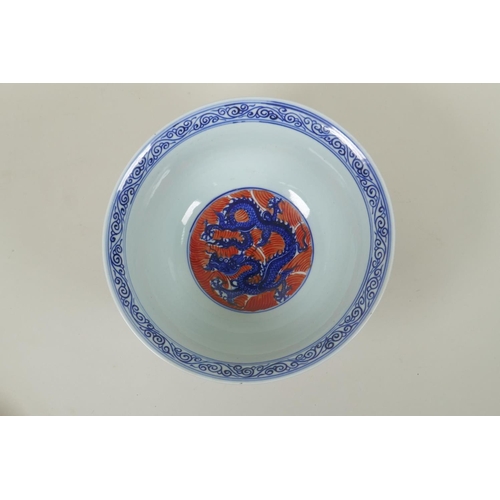 193 - A Chinese blue and white porcelain bowl decorated with dragons on red saves, Xuande 6 character mark... 