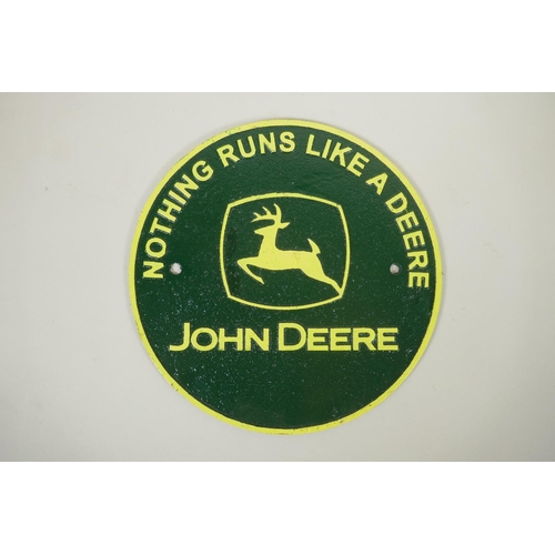 194 - A painted cast iron 'John Deere' plaque, 24cm diameter