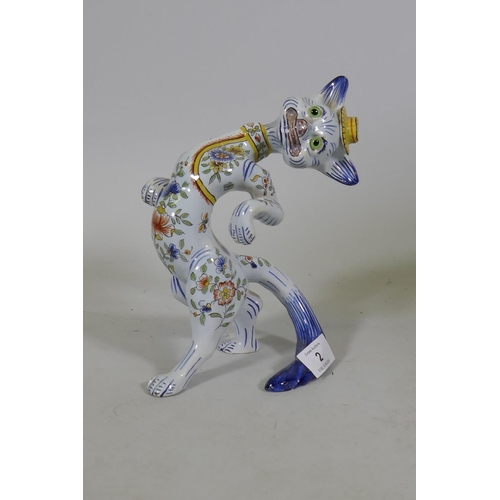 2 - A vintage French faience figure of a cat in a hat, with glass eyes, 20cm high