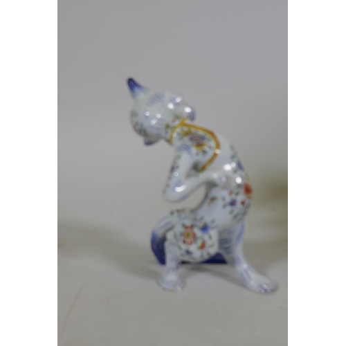 2 - A vintage French faience figure of a cat in a hat, with glass eyes, 20cm high