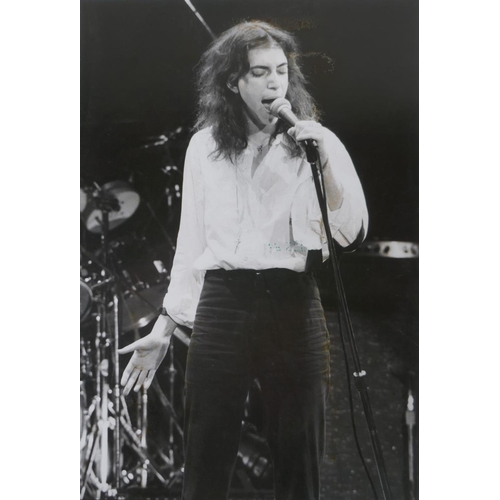 203 - A black and white photograph of Patti Smith at Wembley Arena, 1979, photographed by Jill Furmanovsky... 