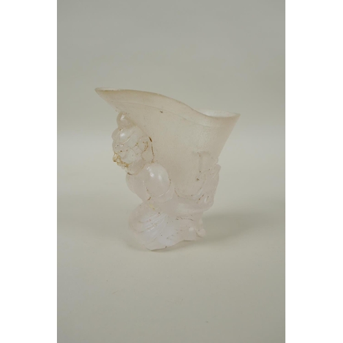 212 - A Chinese moulded glass libation cup with figural decoration, 10cm high