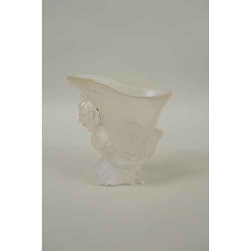 212 - A Chinese moulded glass libation cup with figural decoration, 10cm high