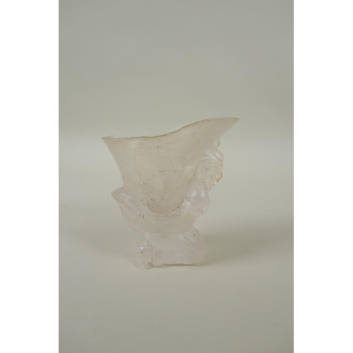 212 - A Chinese moulded glass libation cup with figural decoration, 10cm high