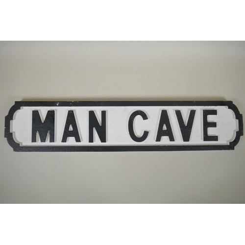 214 - A painted wood 'Man Cave' road sign, 14 x 64cm