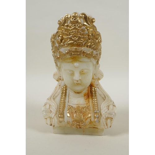 215 - A Chinese carved hardstone bust of Quan Yin, with gilt painted highlights, 20cm high