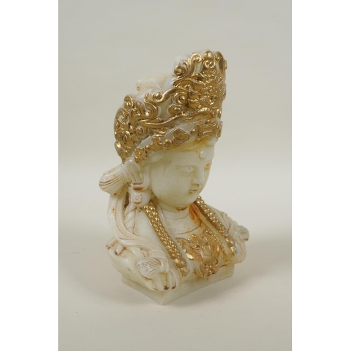 215 - A Chinese carved hardstone bust of Quan Yin, with gilt painted highlights, 20cm high