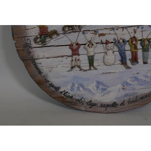 22 - A decorative painted pine panel celebrating French winter sports, 64cm diameter