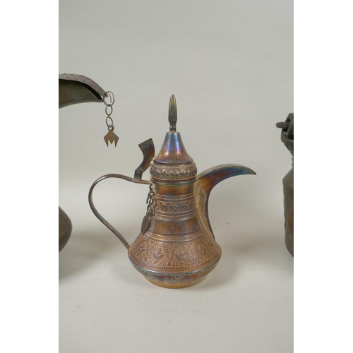 224 - A middle eastern brass coffee pot with chased decoration, a smaller white metal coffee pot and an an... 