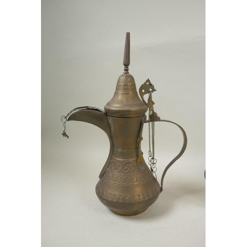 224 - A middle eastern brass coffee pot with chased decoration, a smaller white metal coffee pot and an an... 