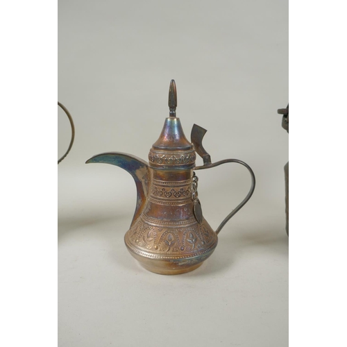 224 - A middle eastern brass coffee pot with chased decoration, a smaller white metal coffee pot and an an... 