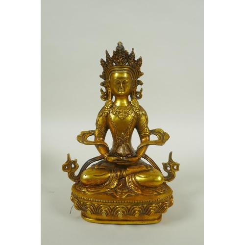 225 - A Sino Tibetan gilt metal Buddha seated on a lotus pond, impressed double vajra mark to base, 20cm h... 