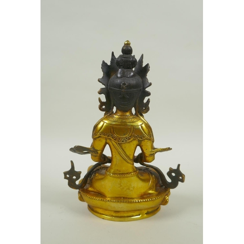 225 - A Sino Tibetan gilt metal Buddha seated on a lotus pond, impressed double vajra mark to base, 20cm h... 