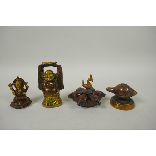 226 - An Indian bronze tikka box, together with a bronze conch incense holder, a miniature bronze ganesh a... 