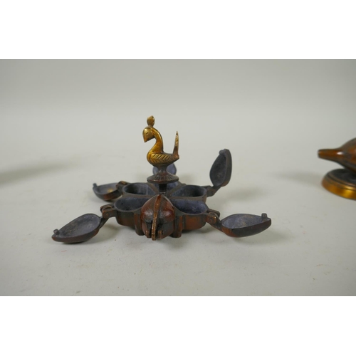 226 - An Indian bronze tikka box, together with a bronze conch incense holder, a miniature bronze ganesh a... 