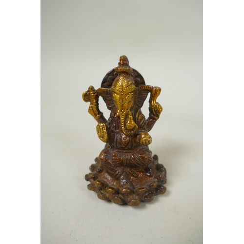 226 - An Indian bronze tikka box, together with a bronze conch incense holder, a miniature bronze ganesh a... 