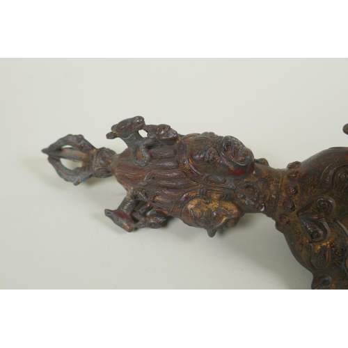 232 - A Tibetan ceremonial bronze vajra with the remnants of gilt patina, 29cm long