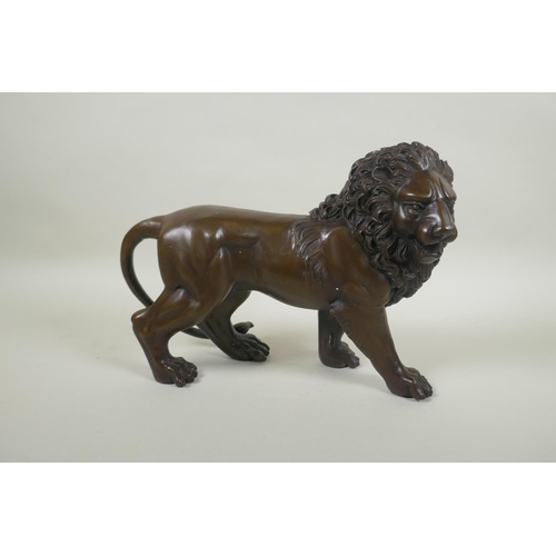 234 - A filled bronze lion, 31cm long