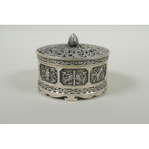 236 - A Tibetan white metal cylinder censer with pierced cover and raised decoration of the eight Buddhist... 