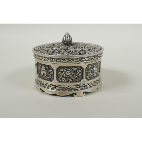 236 - A Tibetan white metal cylinder censer with pierced cover and raised decoration of the eight Buddhist... 