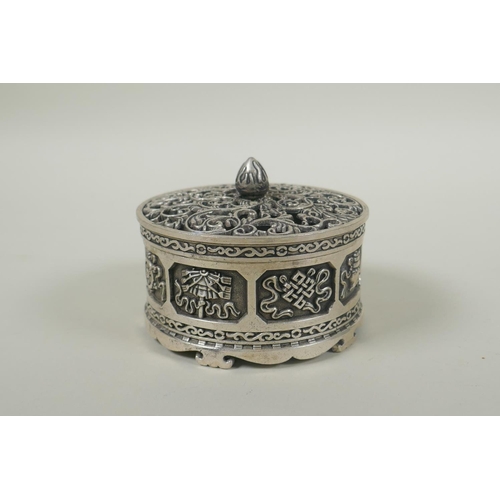 236 - A Tibetan white metal cylinder censer with pierced cover and raised decoration of the eight Buddhist... 