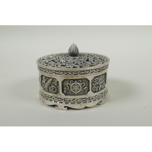 236 - A Tibetan white metal cylinder censer with pierced cover and raised decoration of the eight Buddhist... 