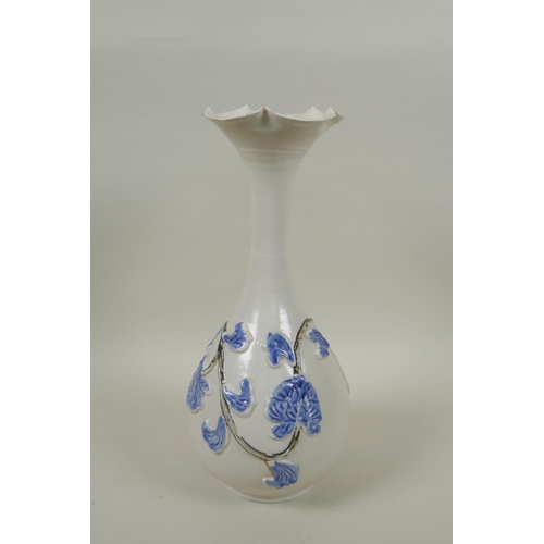 238 - A Japanese blue and white porcelain pear shaped vase with flared rim and vine decoration, 30cm high