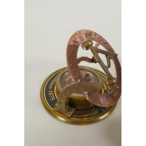 242 - A brass bound glass ball pendant clock, and a reproduction Stanley compass, and another, largest 8cm... 