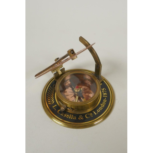 242 - A brass bound glass ball pendant clock, and a reproduction Stanley compass, and another, largest 8cm... 