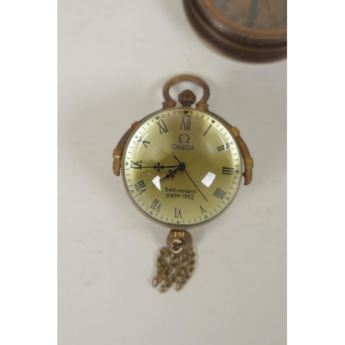 242 - A brass bound glass ball pendant clock, and a reproduction Stanley compass, and another, largest 8cm... 