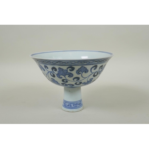 246 - A Chinese blue and white porcelain stem cup with scrolling decoration, Xuande 6 character mark to bo... 