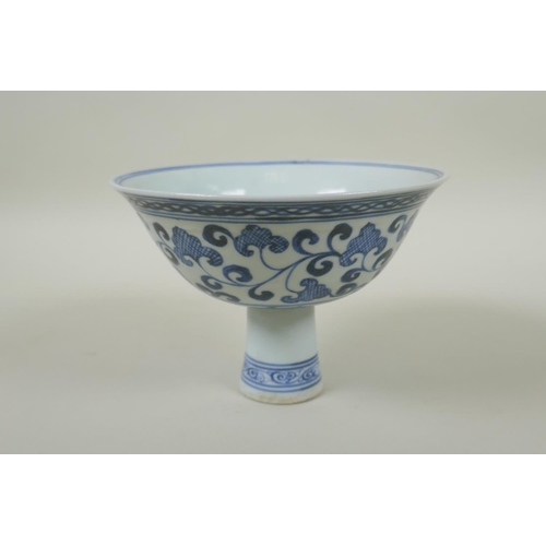 246 - A Chinese blue and white porcelain stem cup with scrolling decoration, Xuande 6 character mark to bo... 