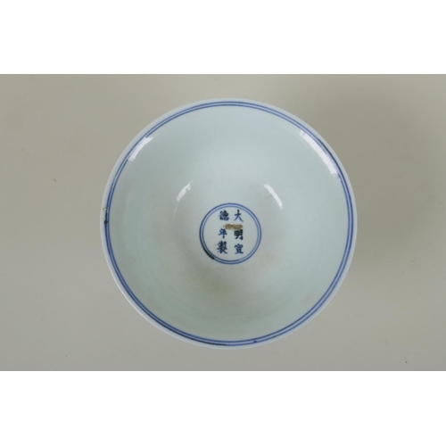 246 - A Chinese blue and white porcelain stem cup with scrolling decoration, Xuande 6 character mark to bo... 