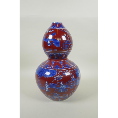 256 - A Chinese copper red glazed porcelain double gourd vase, with blue and white decoration of figures i... 