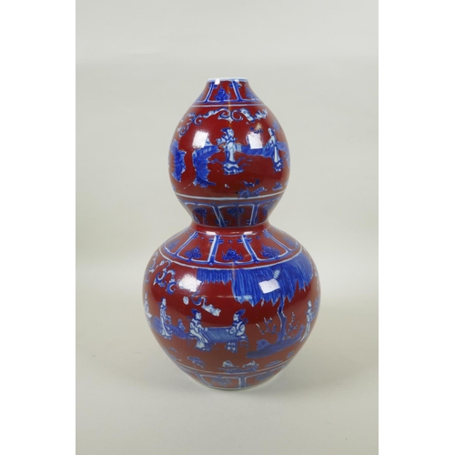 256 - A Chinese copper red glazed porcelain double gourd vase, with blue and white decoration of figures i... 