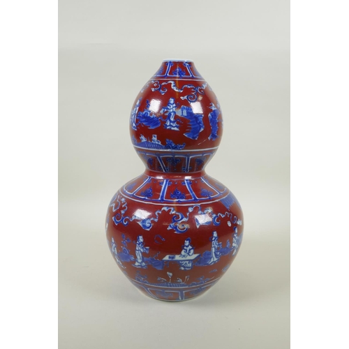 256 - A Chinese copper red glazed porcelain double gourd vase, with blue and white decoration of figures i... 