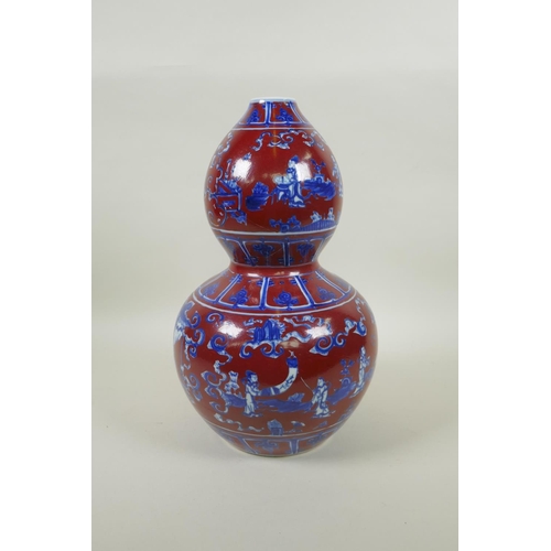 256 - A Chinese copper red glazed porcelain double gourd vase, with blue and white decoration of figures i... 