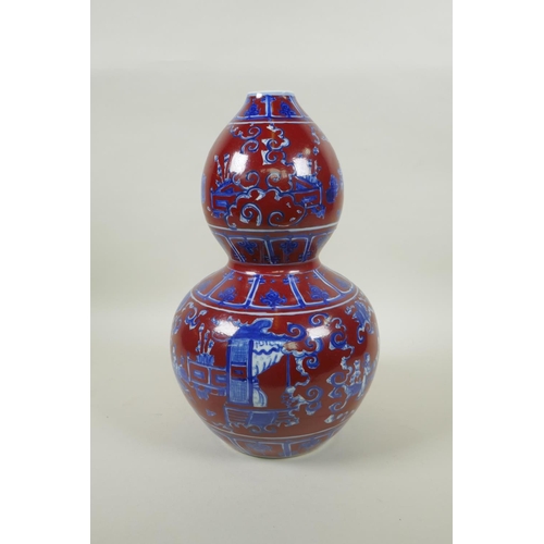 256 - A Chinese copper red glazed porcelain double gourd vase, with blue and white decoration of figures i... 