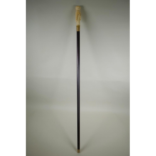 257 - A walking stick with handle in the form of a hand, inset with a compass, 100cm