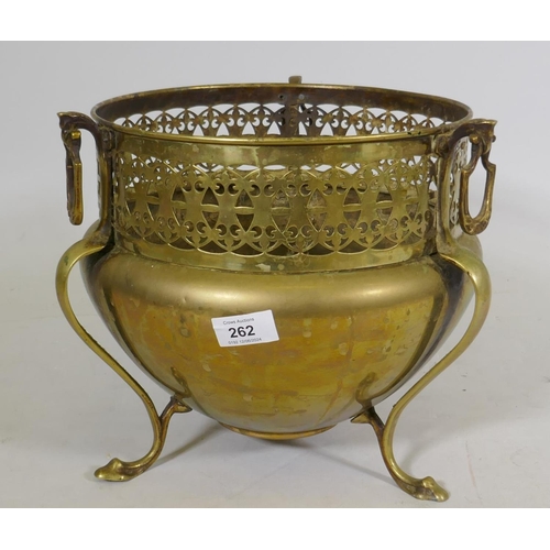 262 - An Art Nouveau brass jardinere, with pierced body and ring handles raised on tripod supports, 26cm h... 