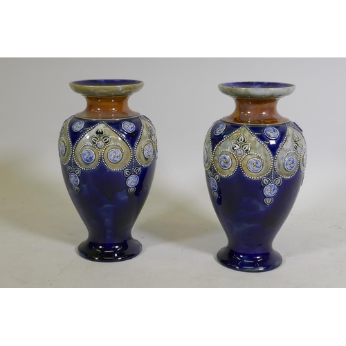 273 - A pair of Royal Doulton blue ground vases signed to the base, 29cm high