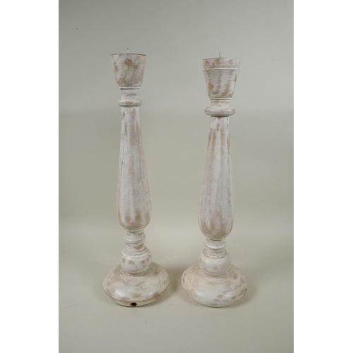 274 - A pair of turned wood pricket candlesticks with a painted and distressed finish, 46cm high