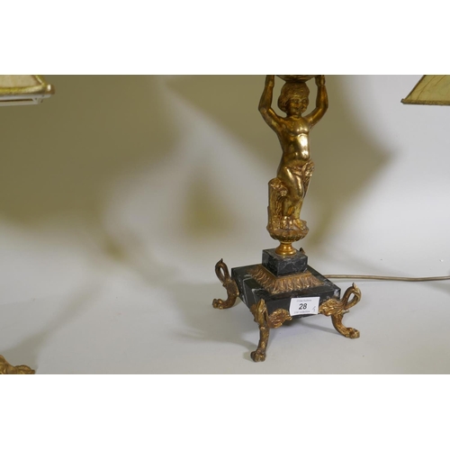 28 - A gilt brass table lamp in the form of putto, on a marble base with paw feet, (one requires re-fixin... 