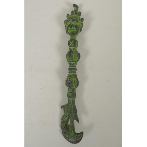 284 - A Tibetan cast iron phurba and matching kartika, 19cm