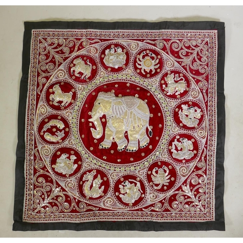 287 - A Thai stump work wall hanging decorated with an elephant surrounded by the zodiac, 95 x 95cm