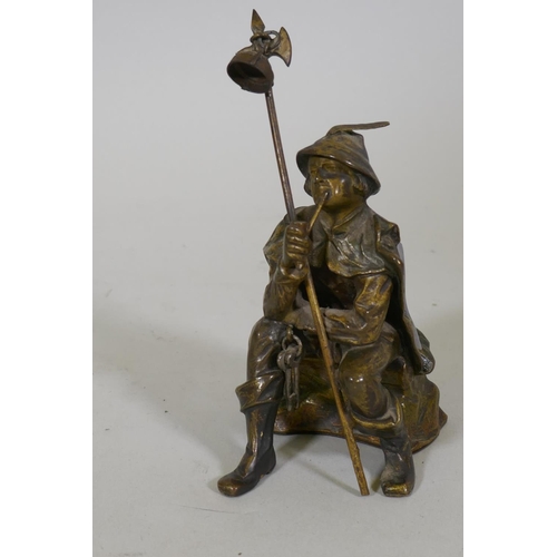 29 - An antique bronze lamp figure of a smoking watchman, 13cm high