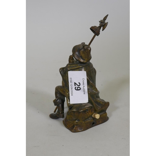 29 - An antique bronze lamp figure of a smoking watchman, 13cm high